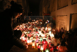 epa05006354 People light candles at the Powazki Cemetery, the oldest cemetery in Warsaw, Poland, on All Saints Day, 01 November 2015. EPA/PAWEL SUPERNAK POLAND OUT