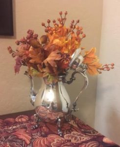 Silver teapot with autumn flowers