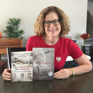 Katrina Shawver holding the Polish edition of HENRY: A Polish Swimmer's True Story of Friendship from Auschwitz to America