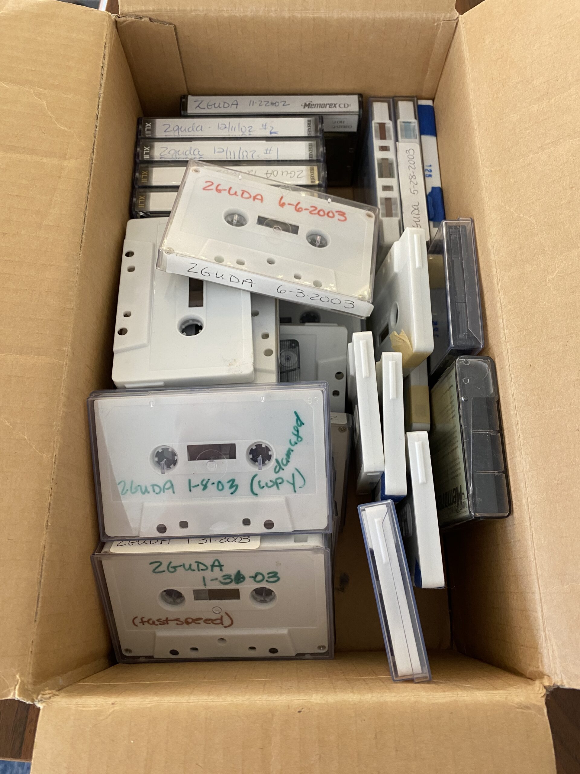 Shoebox of cassette tapes