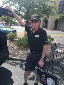 Older gentleman loading groceries