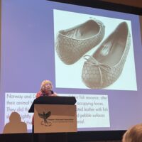 Lois Lowry presenting about Danish "fish" shoes during a presentation